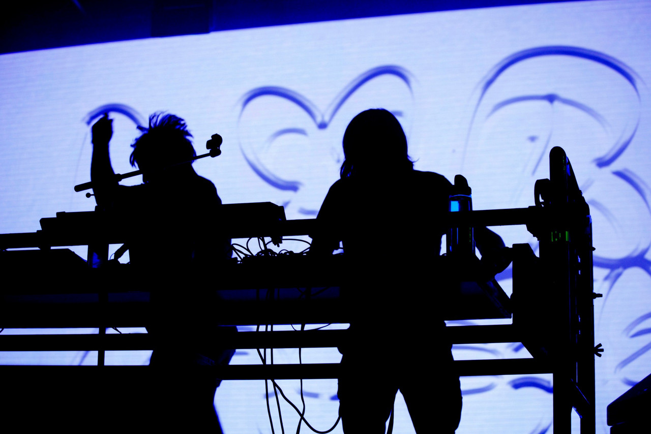 Two silhouettes of performers on stage at the Roskilde festival