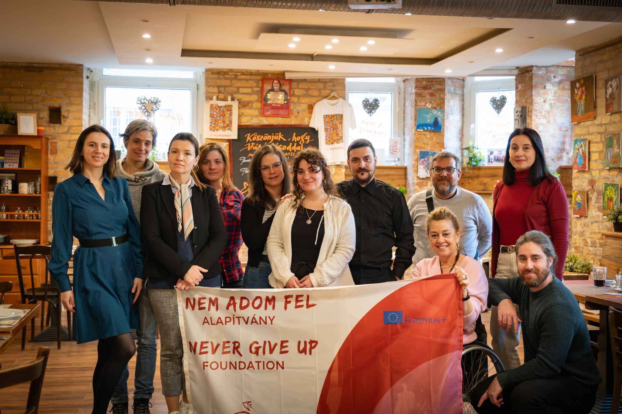 Image of the Be a Volunteer! project partners, holding a Nem Adom Fel banner.